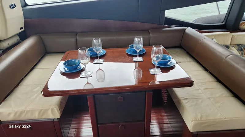 Zen Yacht Photos Pics Luxurious dining area on 2015 Sea Ray L650 Fly yacht with elegant table setting.