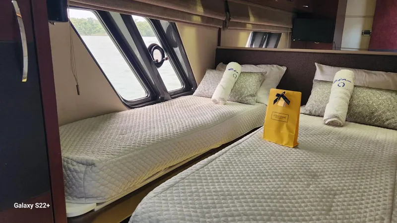 Zen Yacht Photos Pics Luxurious 2015 Sea Ray L650 Fly cabin with twin beds and elegant decor.