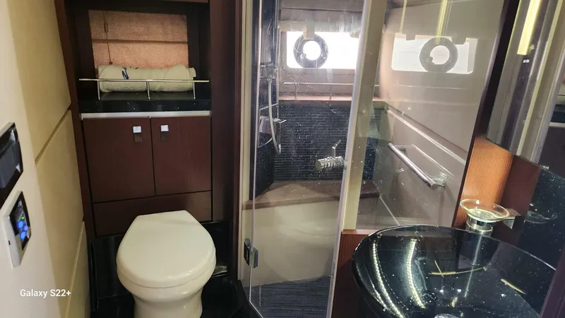 Zen Yacht Photos Pics Luxurious bathroom in 2015 Sea Ray L650 Fly yacht with modern fixtures and elegant design.