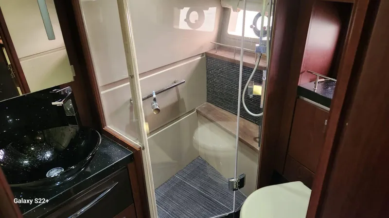 Zen Yacht Photos Pics Luxurious bathroom in 2015 Sea Ray L650 Fly yacht with modern fixtures and glass shower.
