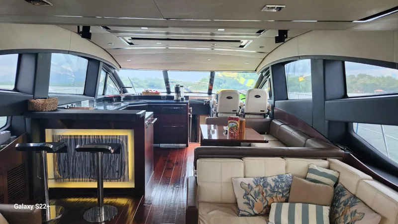 Zen Yacht Photos Pics Luxurious interior of 2015 Sea Ray L650 Fly yacht with modern furnishings and panoramic windows.