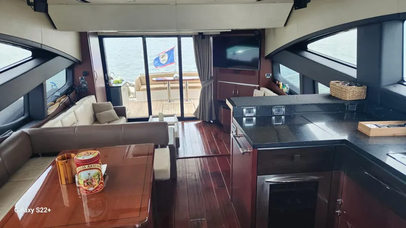 Zen Yacht Photos Pics Luxurious interior of 2015 Sea Ray L650 Fly yacht with elegant furnishings and ocean view.