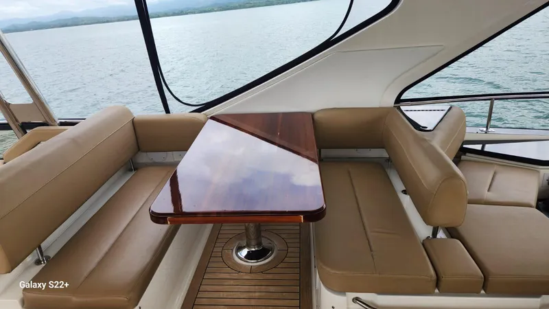 Zen Yacht Photos Pics Luxurious seating area on 2015 Sea Ray L650 Fly yacht with wooden table.