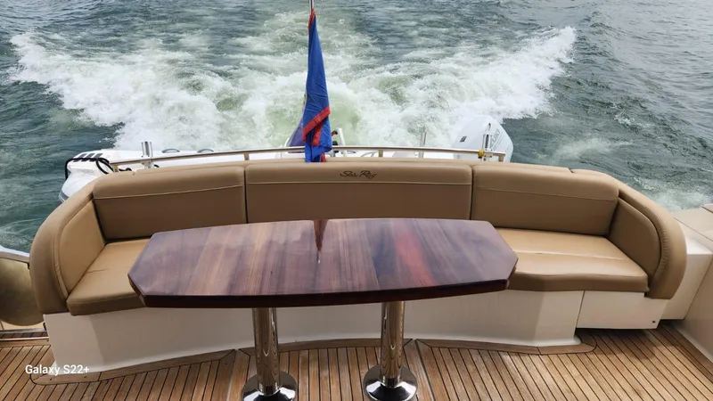 Zen Yacht Photos Pics Luxurious 2015 Sea Ray L650 Fly yacht with elegant seating and wooden table on deck.