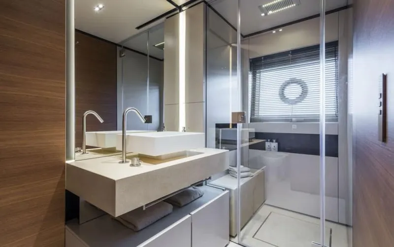  Yacht Photos Pics Luxurious bathroom in 2024 Custom Line Navetta 33 yacht with modern fixtures and elegant design.