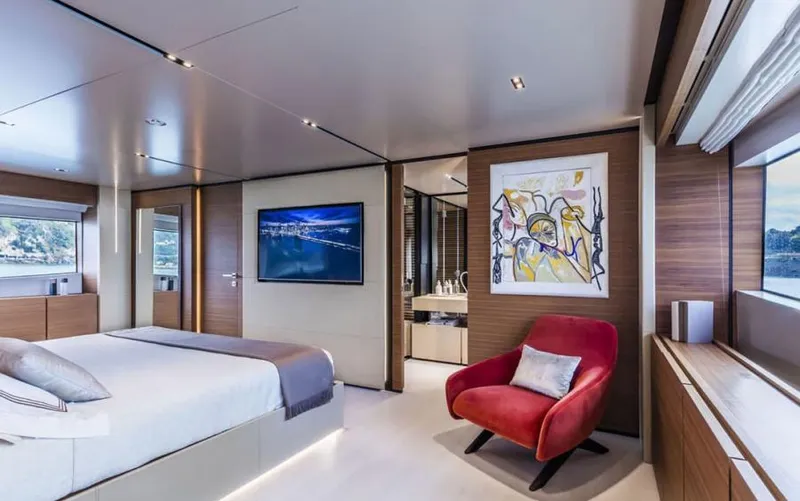  Yacht Photos Pics Luxurious bedroom interior on 2024 Custom Line Navetta 33 yacht, featuring modern decor and artwork.