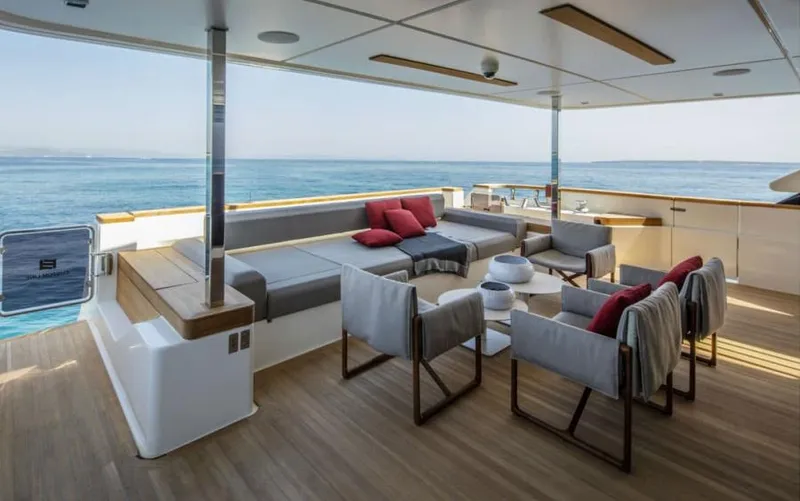  Yacht Photos Pics Luxurious 2024 Custom Line Navetta 33 yacht deck with elegant seating and ocean view.