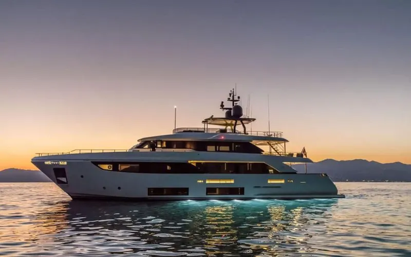  Yacht Photos Pics 2024 Custom Line Navetta 33 yacht at sunset on calm waters.