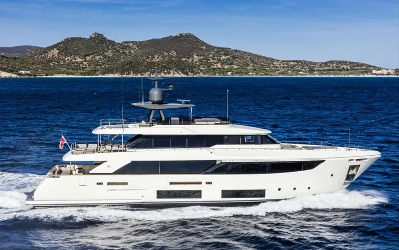  Yacht Photos Pics 2024 Custom Line Navetta 33 yacht cruising on blue ocean near scenic coastline.