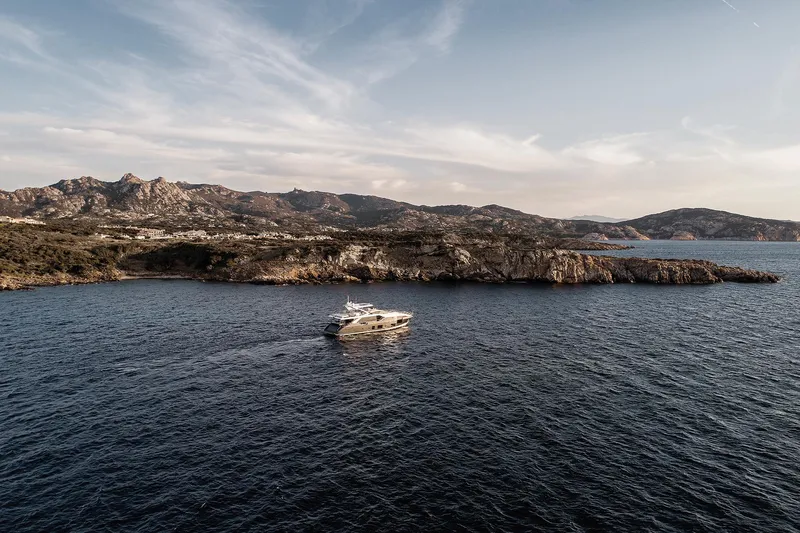  Yacht Photos Pics Azimut Grande 27M yacht cruising near rocky coastline, 2025 model.