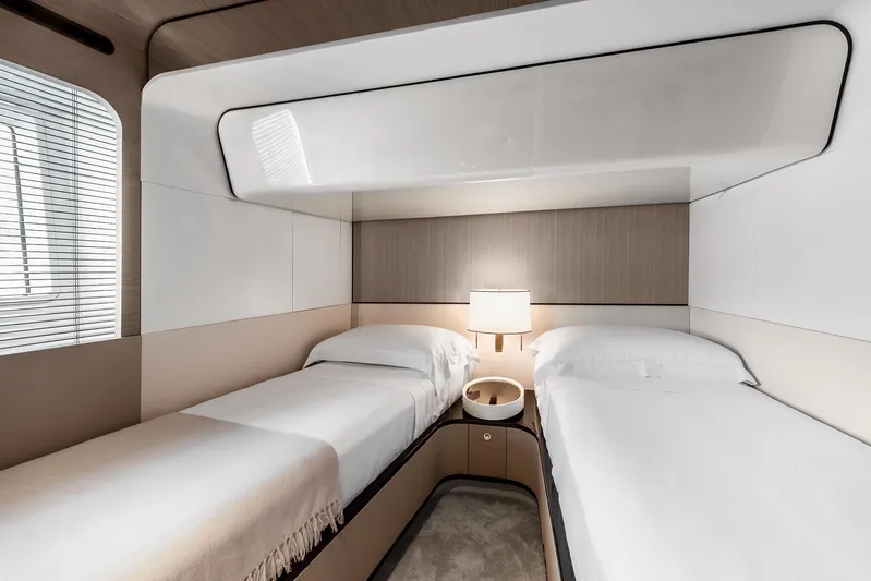  Yacht Photos Pics Luxurious twin cabin interior of 2025 Azimut Grande 27M yacht, featuring modern design and cozy ambiance.