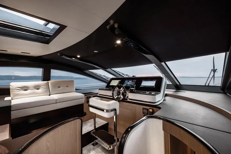  Yacht Photos Pics Luxurious interior of 2025 Azimut Grande 27M yacht with modern helm and seating.