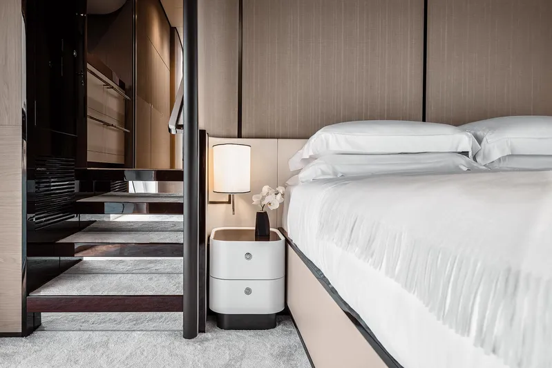  Yacht Photos Pics Luxurious bedroom interior of 2025 Azimut Grande 27M yacht with modern design and elegant furnishings.