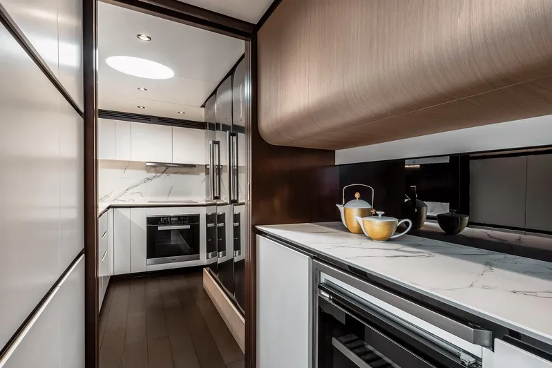  Yacht Photos Pics Luxurious kitchen interior of 2025 Azimut Grande 27M yacht with modern appliances and elegant design.