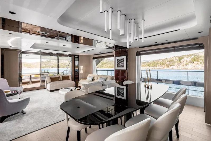  Yacht Photos Pics Luxurious interior of 2025 Azimut Grande 27M yacht with elegant dining and seating areas.
