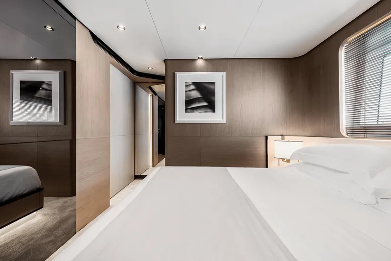  Yacht Photos Pics Luxurious bedroom interior of 2025 Azimut Grande 27M yacht, featuring modern design and elegant decor.