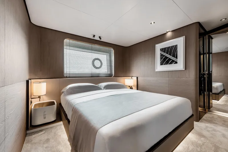  Yacht Photos Pics Luxurious bedroom interior of 2025 Azimut Grande 27M yacht, featuring modern design and elegant decor.