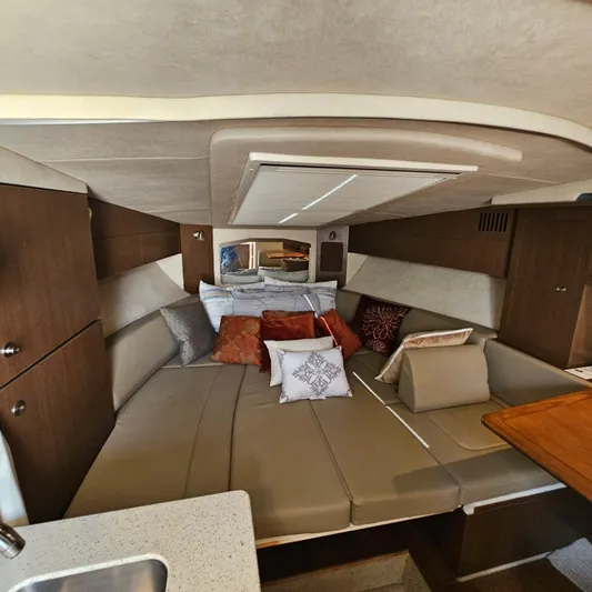  Yacht Photos Pics 2013 Sea Ray 310 Sundancer cabin interior with cozy seating and decorative pillows.