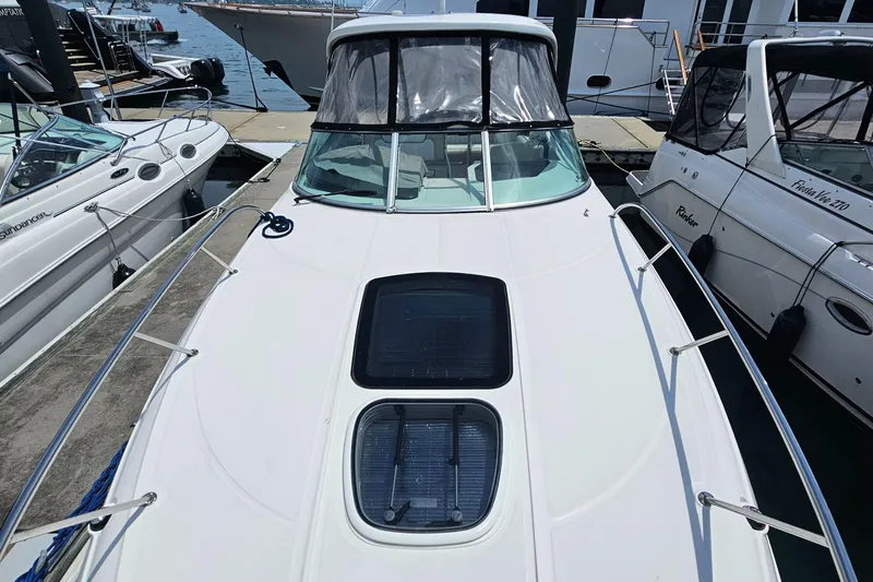  Yacht Photos Pics 2013 Sea Ray 310 Sundancer docked at marina, showcasing sleek design and spacious deck.