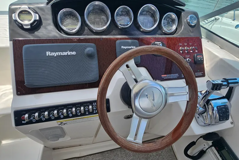  Yacht Photos Pics 2013 Sea Ray 310 Sundancer helm with Raymarine electronics and wooden steering wheel.