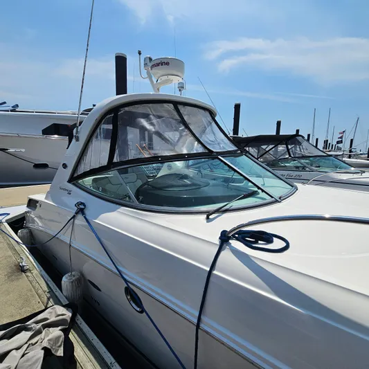  Yacht Photos Pics 2013 Sea Ray 310 Sundancer docked at marina under clear blue sky.