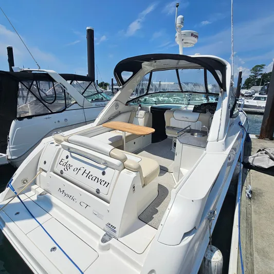  Yacht Photos Pics 2013 Sea Ray 310 Sundancer yacht docked, featuring spacious seating and sleek design.