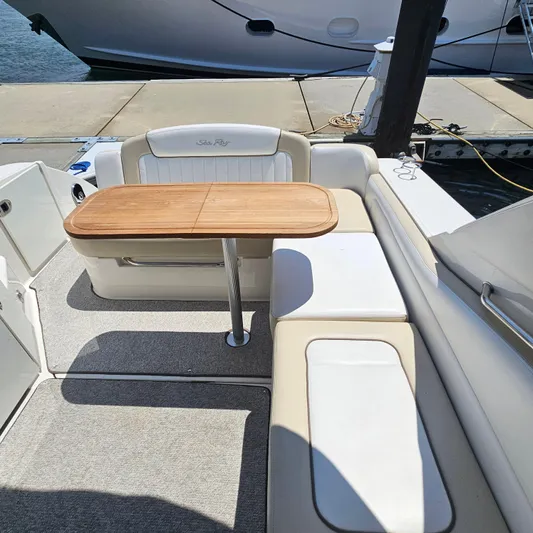  Yacht Photos Pics 2013 Sea Ray 310 Sundancer interior with wooden table and cushioned seating.