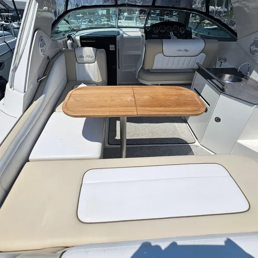  Yacht Photos Pics Interior of 2013 Sea Ray 310 Sundancer with seating, table, and kitchenette.