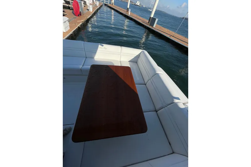  Yacht Photos Pics 2013 Sea Ray 510 Sundancer yacht with white seating and wooden table at dock.