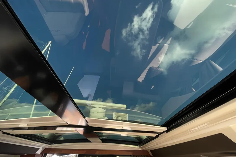  Yacht Photos Pics Glass roof view from 2013 Sea Ray 510 Sundancer, showcasing clear sky and clouds.