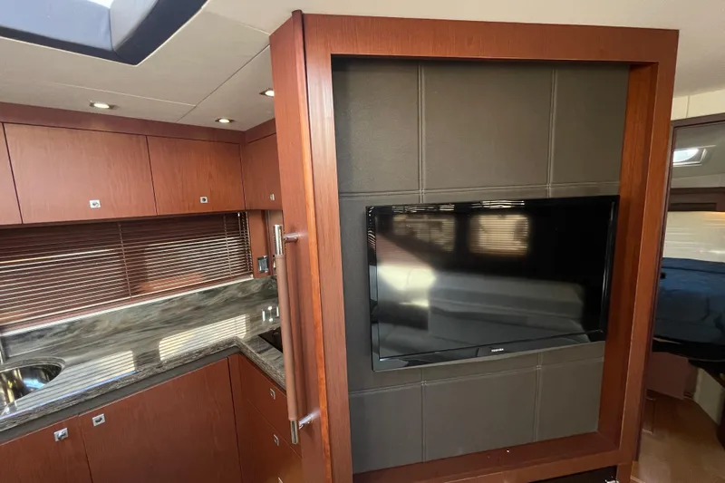  Yacht Photos Pics Luxurious interior of 2013 Sea Ray 510 Sundancer with modern kitchen and wall-mounted TV.