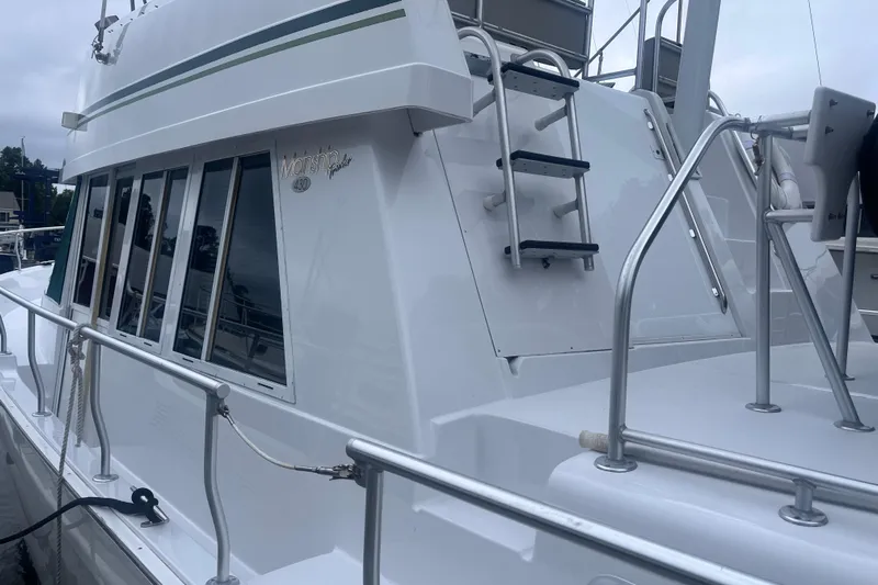  Yacht Photos Pics 2000 Mainship 43 Trawler Aft Cabin with sleek white exterior and ladder.