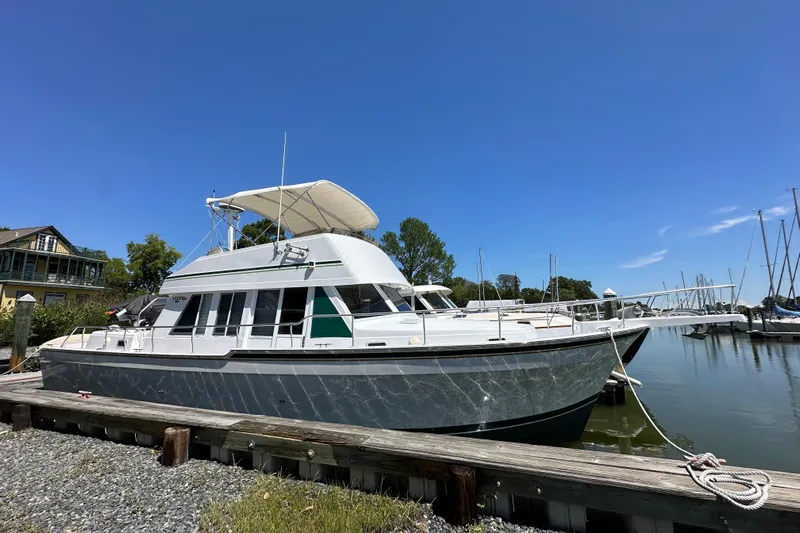  Yacht Photos Pics Mainship 43 Trawler Aft Cabin 2000 docked at marina under clear blue sky.