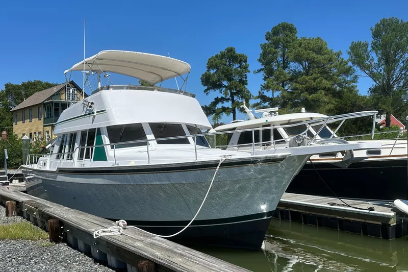  Yacht Photos Pics 2000 Mainship 43 Trawler Aft Cabin docked, featuring sleek design and spacious upper deck.