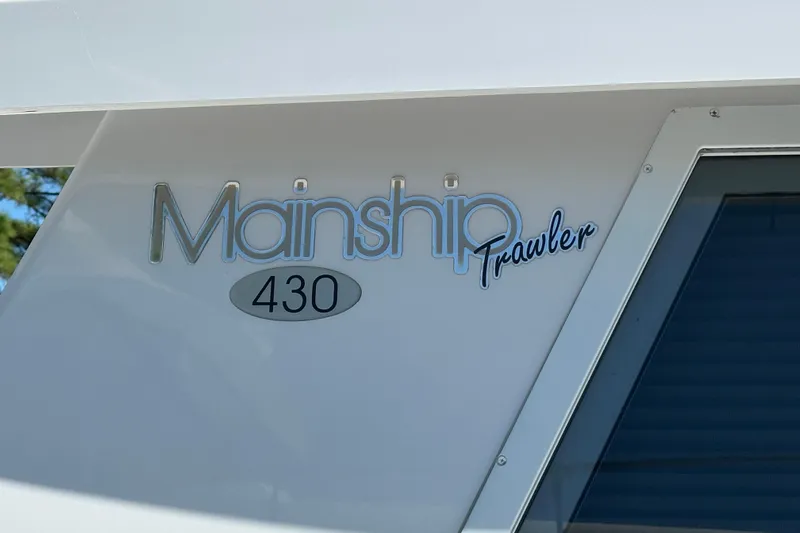  Yacht Photos Pics Mainship 43 Trawler Aft Cabin 2000 logo on boat exterior.