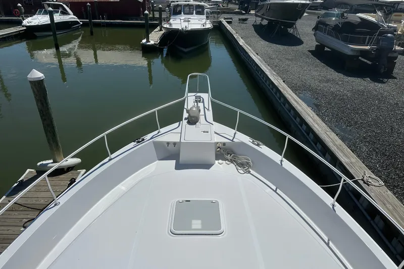  Yacht Photos Pics Bow view of 2000 Mainship 43 Trawler Aft Cabin docked at marina.