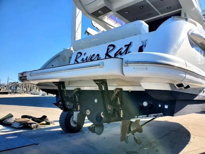 River Rat Yacht Photos Pics 2013 Azimut 45 Flybridge yacht, rear view, docked with visible propellers and "River Rat" name.
