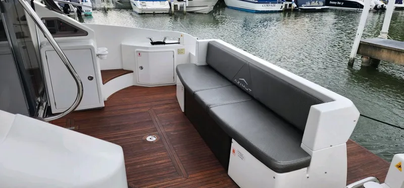 River Rat Yacht Photos Pics Azimut 45 Flybridge 2013 yacht with sleek seating, docked at a marina.