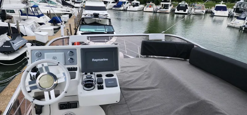 River Rat Yacht Photos Pics Flybridge of 2013 Azimut 45 yacht with Raymarine navigation, docked among other boats.