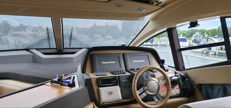 River Rat Yacht Photos Pics Interior view of 2013 Azimut 45 Flybridge yacht cockpit with modern navigation equipment.