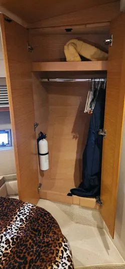 River Rat Yacht Photos Pics Azimut 45 Flybridge 2013 yacht closet with hanging clothes and storage shelf.