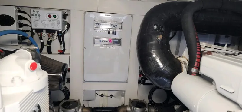 River Rat Yacht Photos Pics Engine room of 2013 Azimut 45 Flybridge yacht, showcasing mechanical components and control panel.