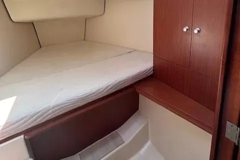  Yacht Photos Pics 2016 Hanse 315 yacht interior cabin with bed and wooden storage.