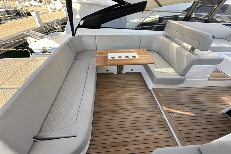  Yacht Photos Pics Luxurious seating area on 2021 Fairline Targa 45 Open yacht with wooden table.