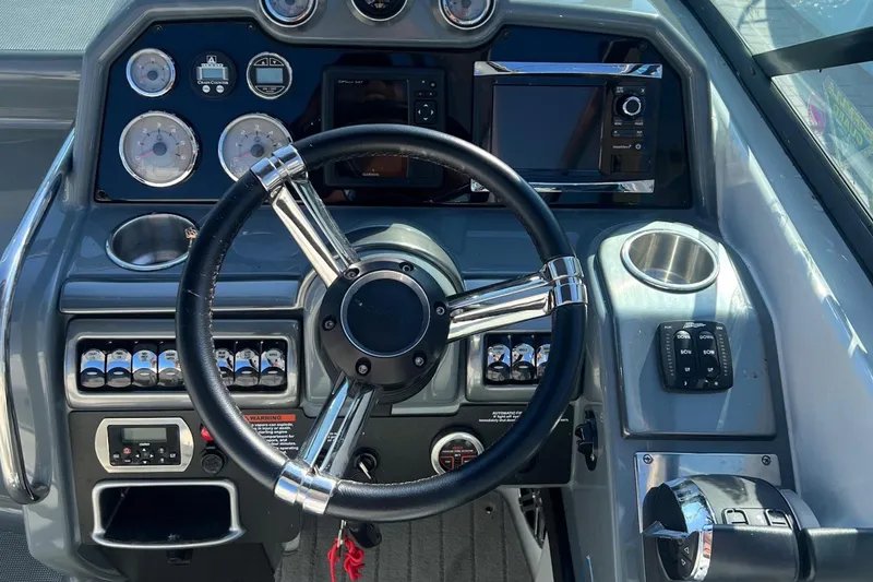  Yacht Photos Pics Dashboard of a 2015 Formula 290 Sun Sport boat with steering wheel and controls.