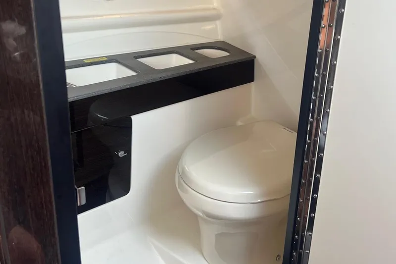  Yacht Photos Pics Interior of 2015 Formula 290 Sun Sport boat bathroom with toilet and counter.