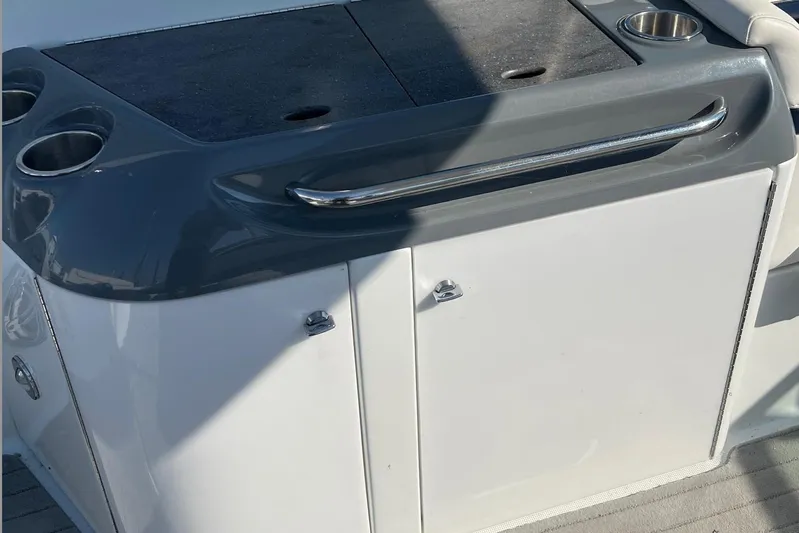  Yacht Photos Pics 2015 Formula 290 Sun Sport boat interior with storage cabinet and cup holders.
