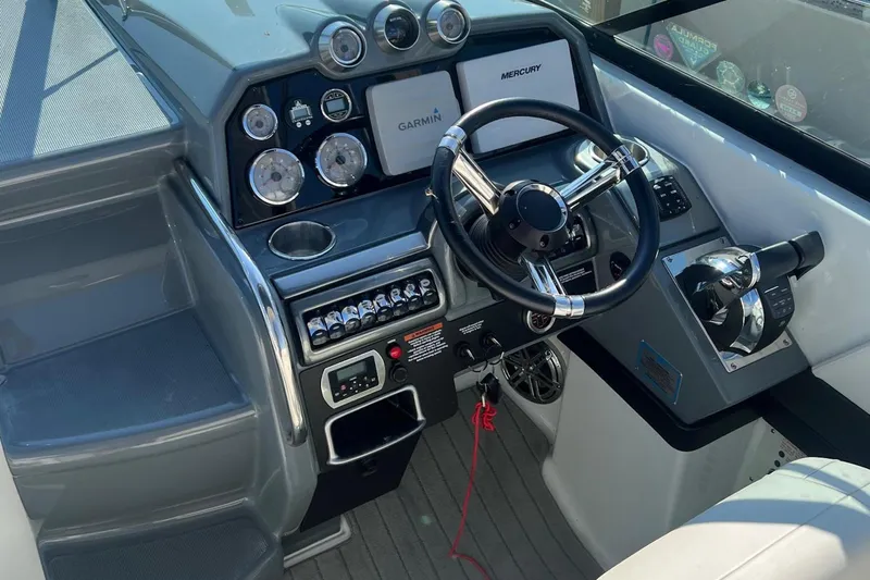  Yacht Photos Pics 2015 Formula 290 Sun Sport boat dashboard with steering wheel and control panel.