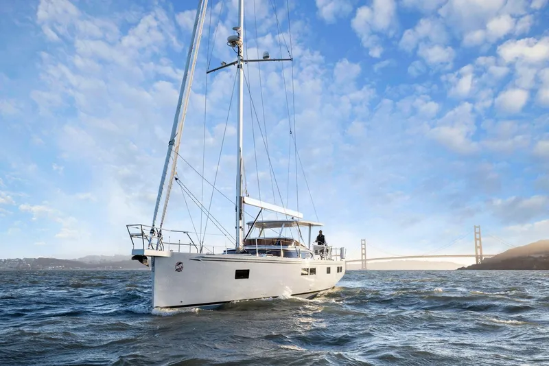 No Retreat Yacht Photos Pics Sailing yacht Hylas H57 (2020) on open water with bridge in background.