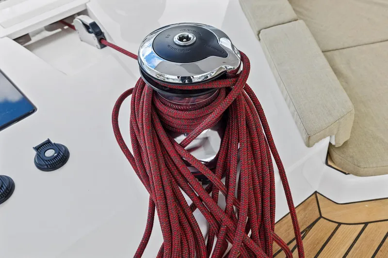 No Retreat Yacht Photos Pics Red rope on winch aboard 2020 Hylas H57 yacht, with teak deck and beige seating.